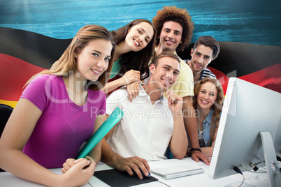 Composite image of smiling students in computer class