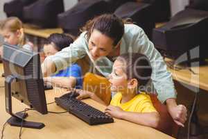 Cute pupils in computer class with teacher