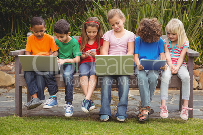 Kids sitting on a park bench