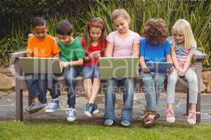 Kids sitting on a park bench