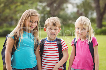 Smiling classmates with schoolbags