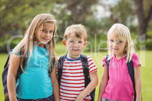 Smiling classmates with schoolbags