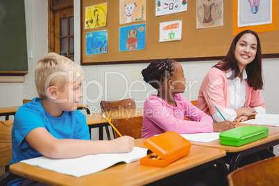 Teacher sitting with her students