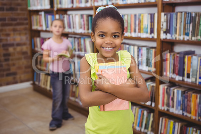 Smiling student holding a few books