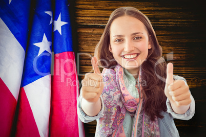 Composite image of woman showing thumbs up