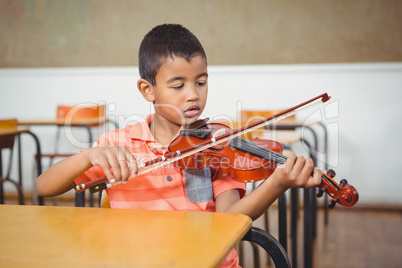 Student using a violin in class