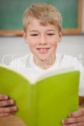 Happy student reading a book