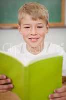 Happy student reading a book