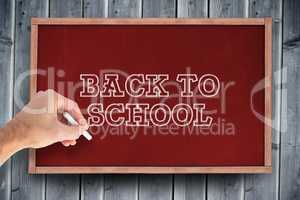 Composite image of hand writing with a white chalk