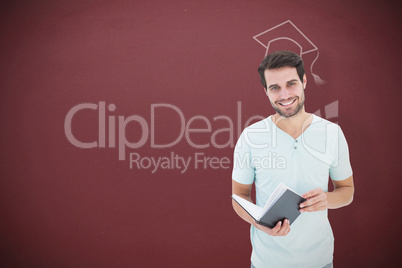 Composite image of student holding book