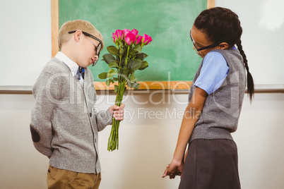Student giving flowers to another student