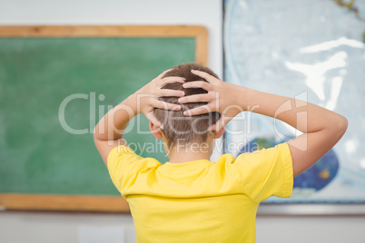 Pupil having hands on head in a classroom