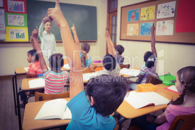 Pupils raising their hands during class