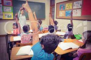 Pupils raising their hands during class