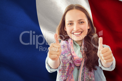 Composite image of woman showing thumbs up