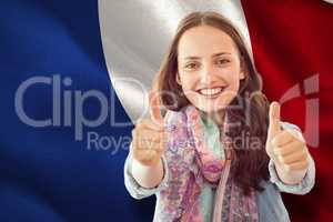 Composite image of woman showing thumbs up