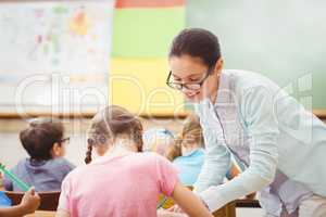 Teacher helping a pupil during class