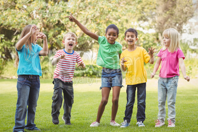 Smiling classmates cheering and standing in a row