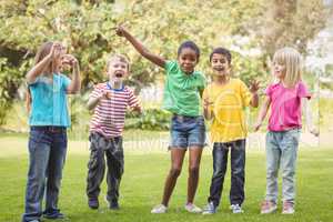 Smiling classmates cheering and standing in a row