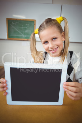 Smiling pupil showing tablet to camera