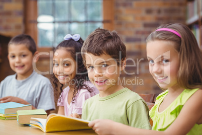 Pupils reading books in library Pupils reading books in library