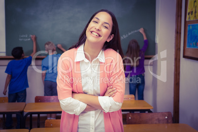 Teacher standing with students at blackboard