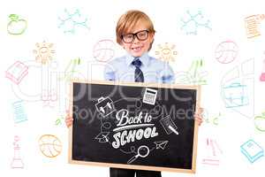 Composite image of cute pupil holding chalkboard