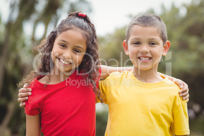 Cute pupils smiling at camera outside