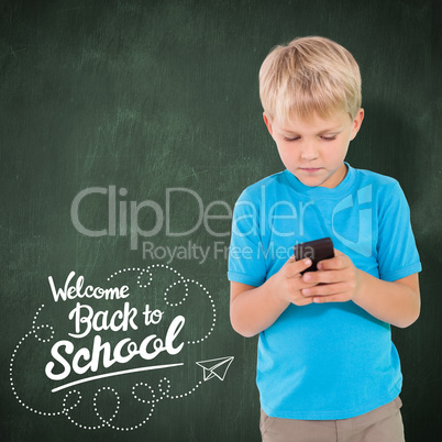 Composite image of cute boy using smartphone