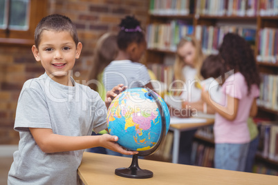Pupil in library with globe