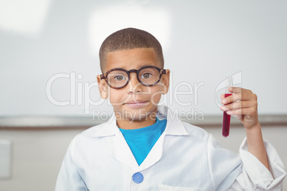 Smiling pupil with lab coat holding test tube