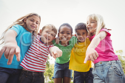 Smiling classmates pointing to camera