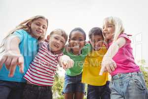 Smiling classmates pointing to camera