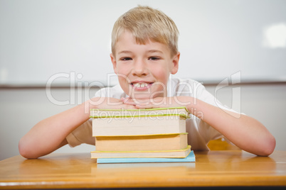 Student resting thie head upon some books