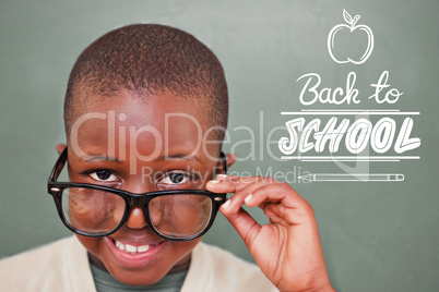 Composite image of cute pupil tilting glasses