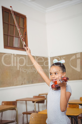 Student using a violin in class