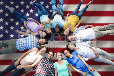 Composite image of happy friends lying in circle