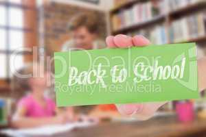 Back to school against teacher helping pupils in library