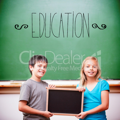 Education against cute pupils showing chalkboard