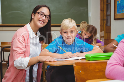 Smiling teacher helping a student