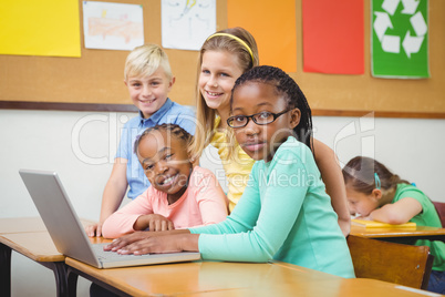 Pupils using a laptop in class