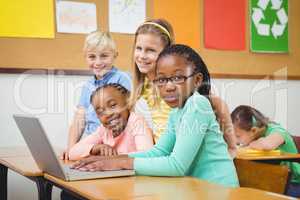 Pupils using a laptop in class