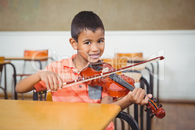 Student using a violin in class