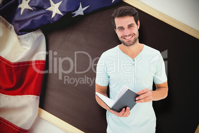 Composite image of student holding book