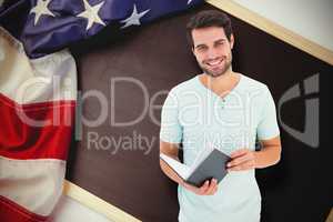 Composite image of student holding book