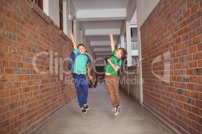 Students running and jumping down the hall
