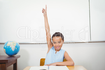 Smiling student with a rasied hand