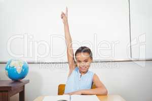 Smiling student with a rasied hand