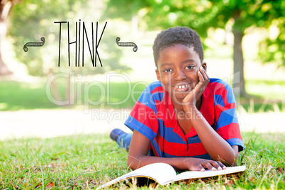 Think against little boy reading in the park