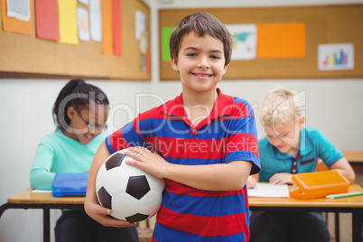 Smiling student holding a football